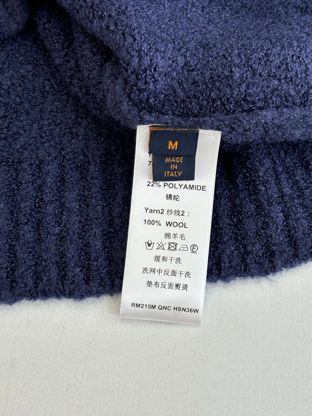 Louis Vuitton sweater care label, size M; 22% polyamide, 100% wool