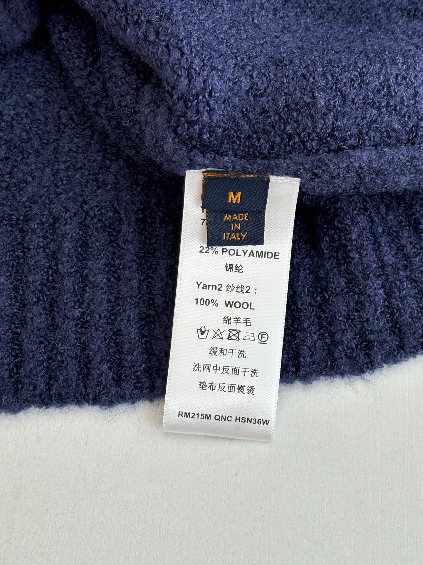 Louis Vuitton sweater care label, size M; 22% polyamide, 100% wool