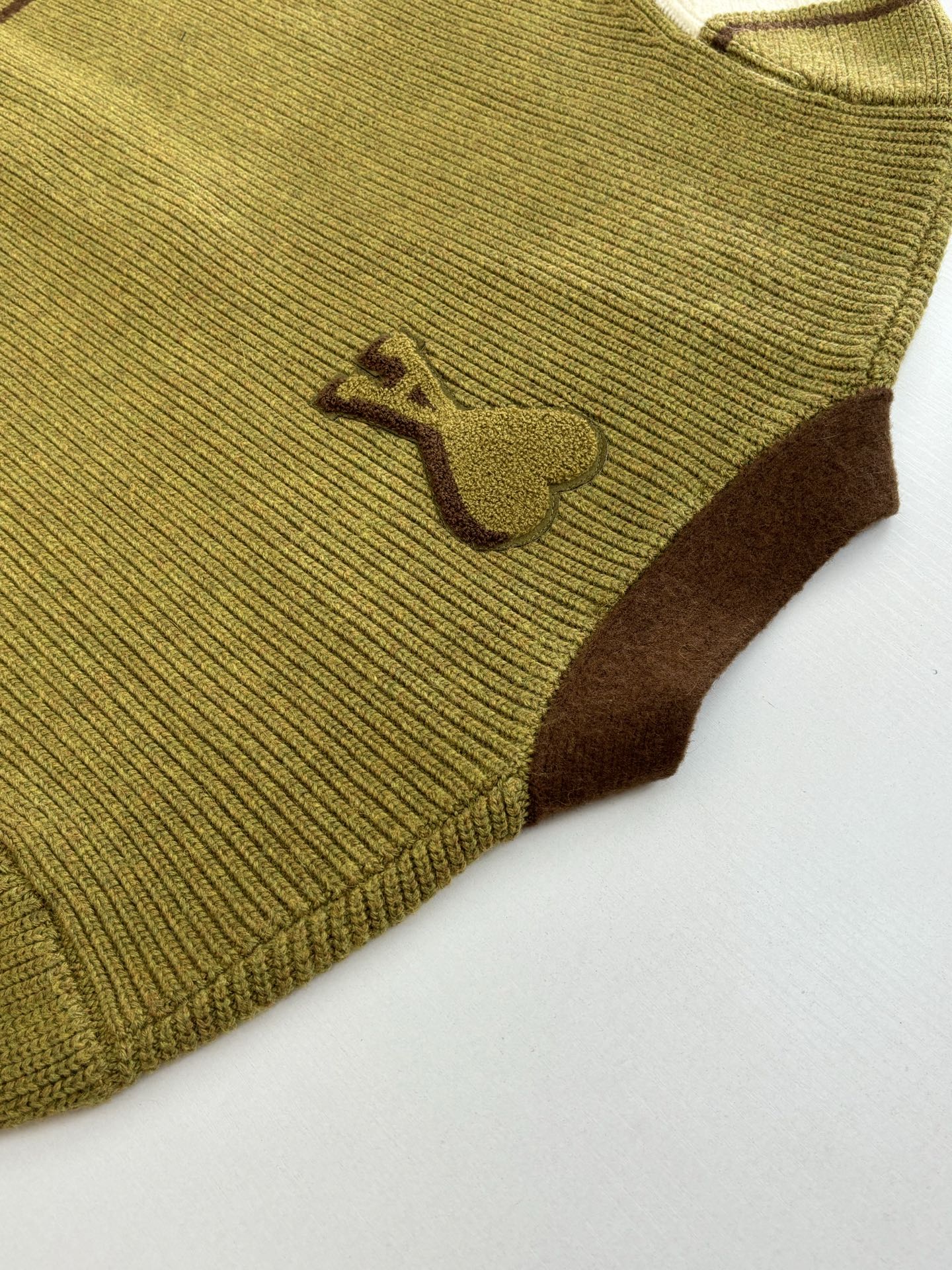 Green knit cardigan chest with small brown heart motif
