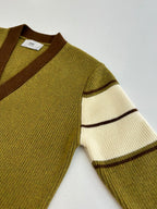 Green knit cardigan sleeve with cream and brown stripe band accents