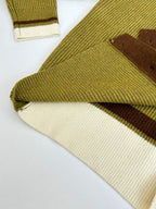 Green knit cardigan hem with cream ribbed trim and brown underlay