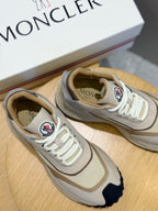Moncler sneakers close-up, cream laces and logo patch on beige upper