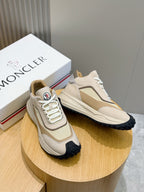 Moncler sneakers pair on stand, cream and beige with white laces