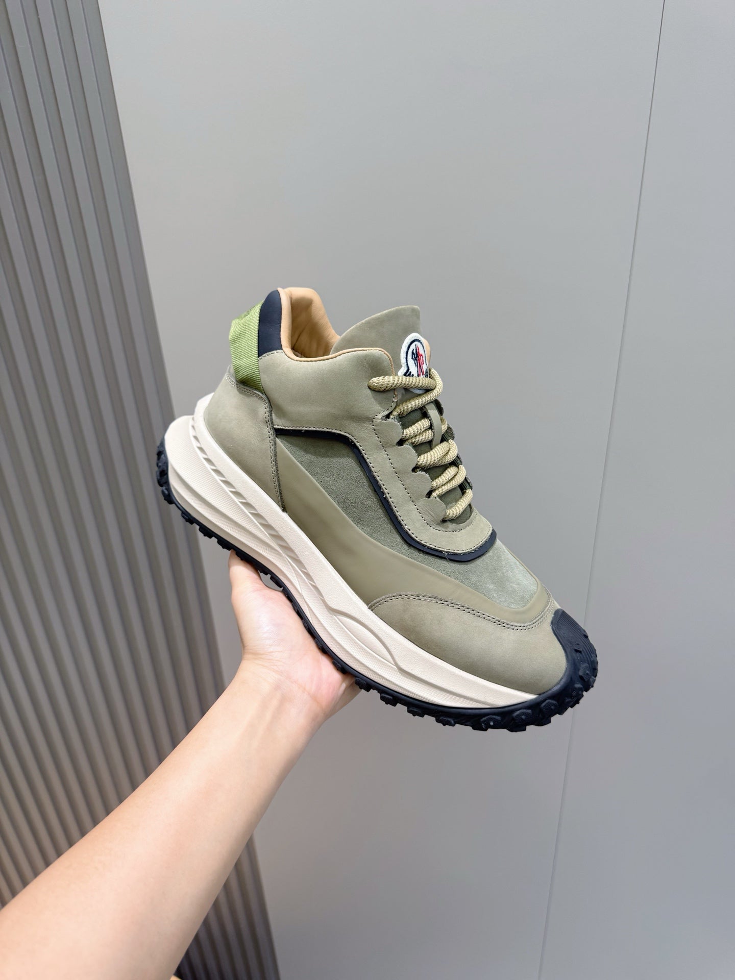 Moncler low-top sneakers, sage green upper with dark navy panel and thick white sole