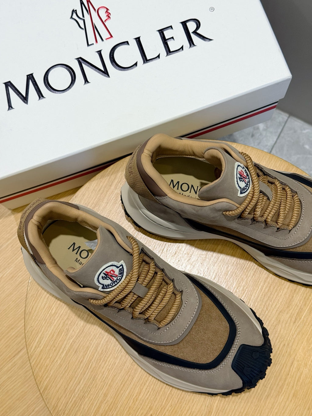 Moncler logo sneakers with gold laces, taupe and navy colorblock and matching insoles