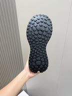 Moncler sneaker outsole in dark blue with rugged tread pattern and raised grip lugs.