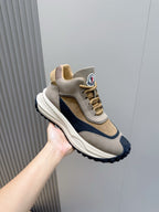 Moncler low-top sneakers in beige and navy with textured rubber sole and logo patch.