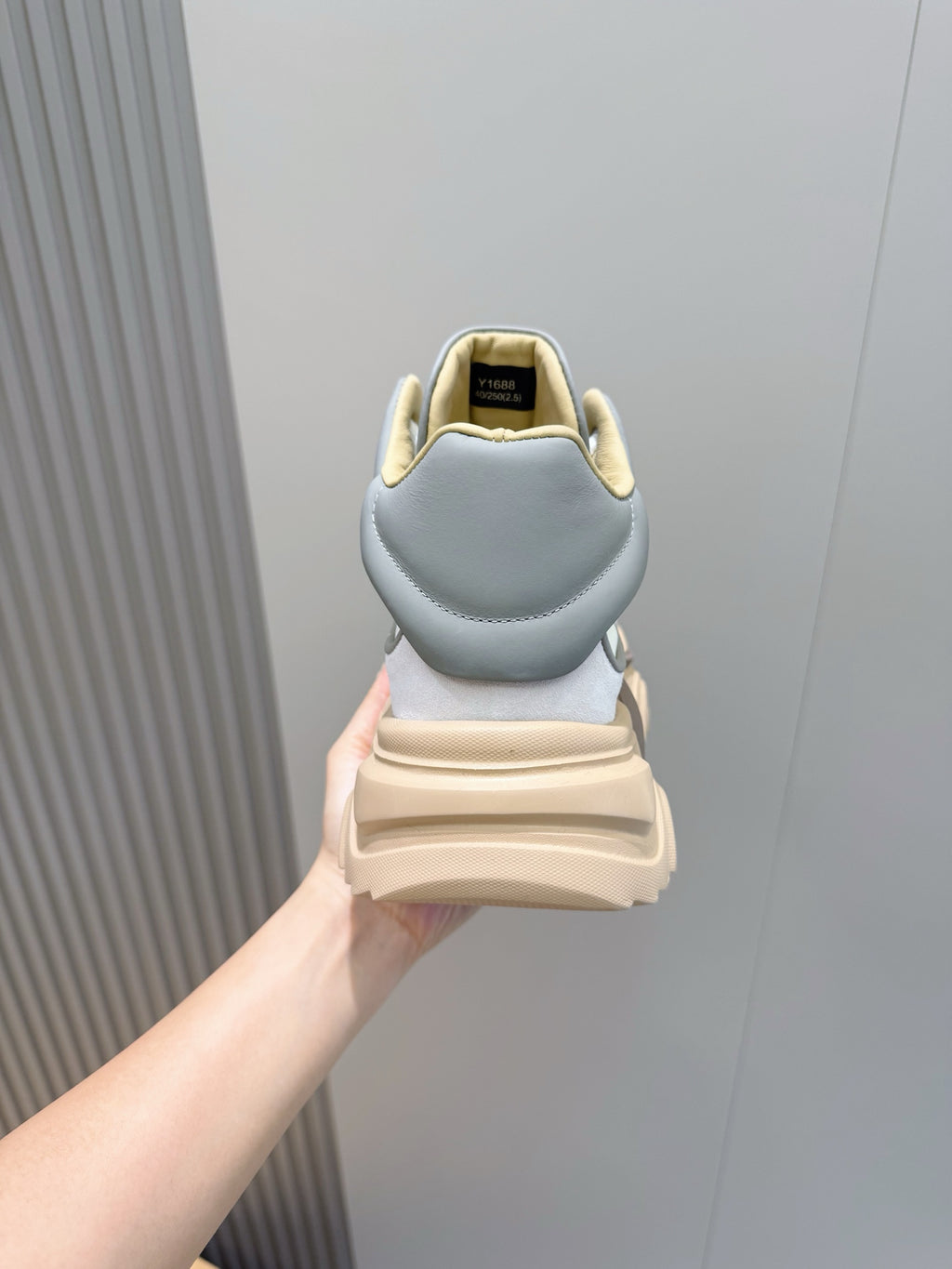 Back view of light blue sneakers with tan sole and heel tab
