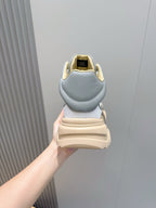 Back view of light blue sneakers with tan sole and heel tab