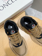 Moncler sneakers close-up, beige and navy uppers with laces and red-white stripe