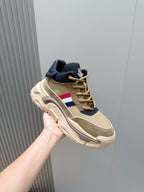 Moncler beige/navy sneaker held up, side view with tricolor stripe and chunky sole