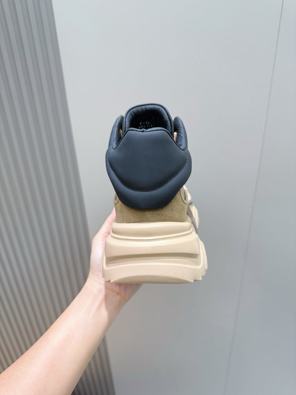 Moncler sneakers heel view, navy collar on beige base with cushioned back