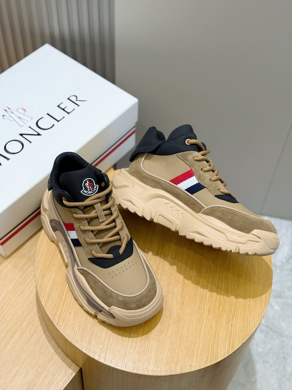 Moncler pair of chunky sneakers, beige uppers with navy accents and red-white stripe