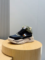 Navy lace-up sneakers with tan collar, white stripe, and thick sole