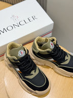 Close-up pair of navy lace-up sneakers with tan collars and white side stripe