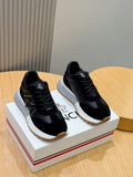 Black lace-up sneakers with white sole and logo patch detail