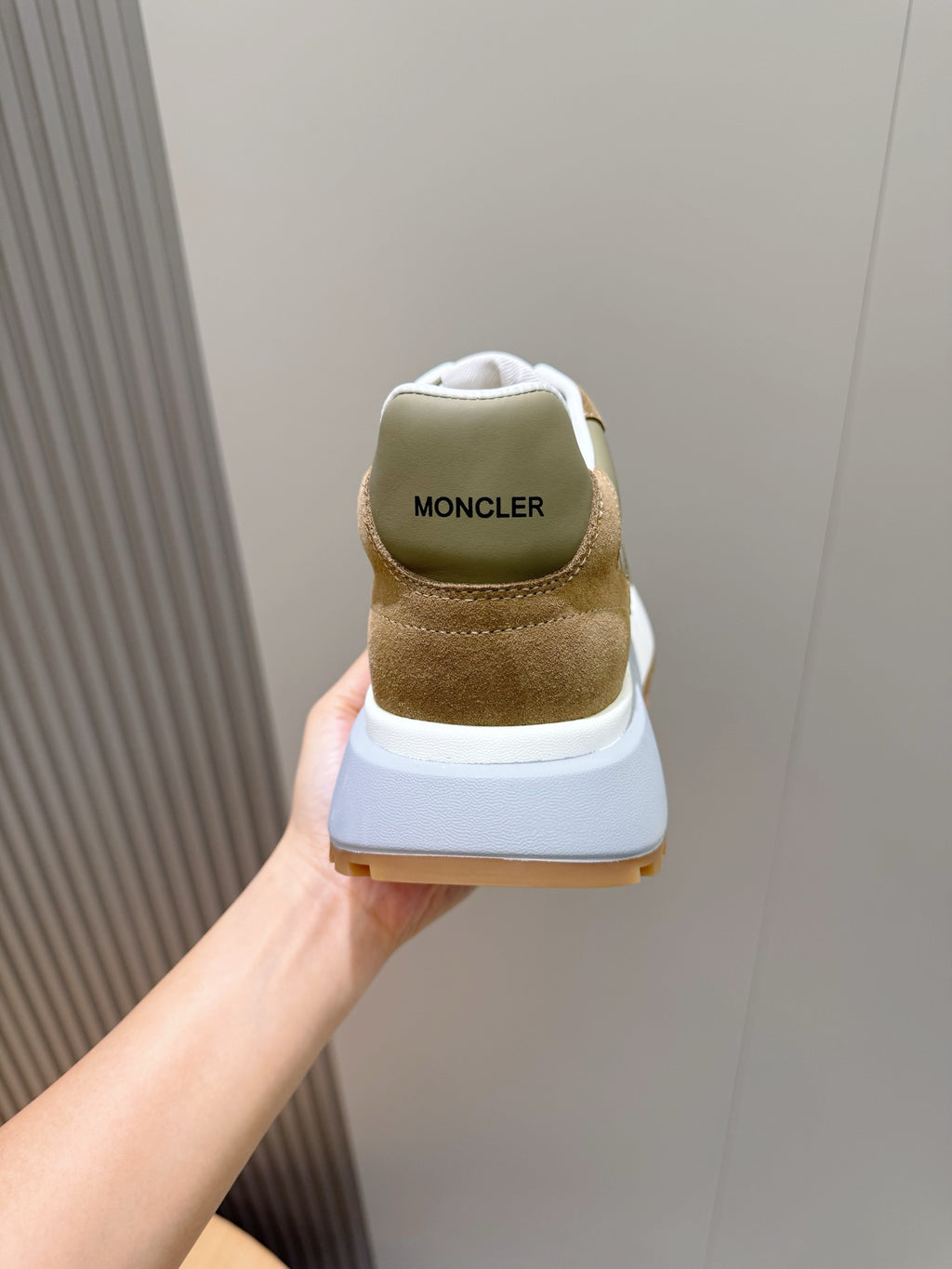Moncler sneaker heel view in olive and tan suede with white outsole