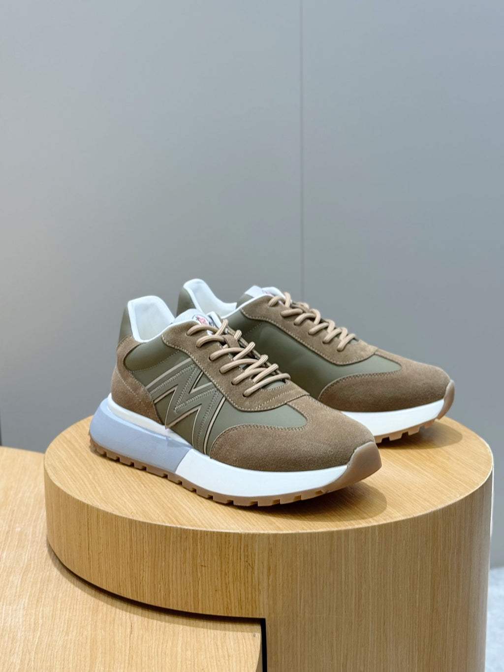 Moncler lace-up sneakers in olive and tan suede with contrasting panel details