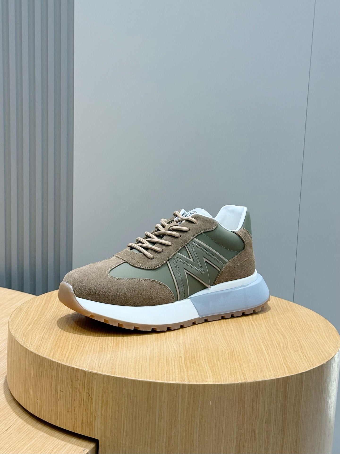 Moncler low-top sneakers in olive and tan with lace-up front and white sole