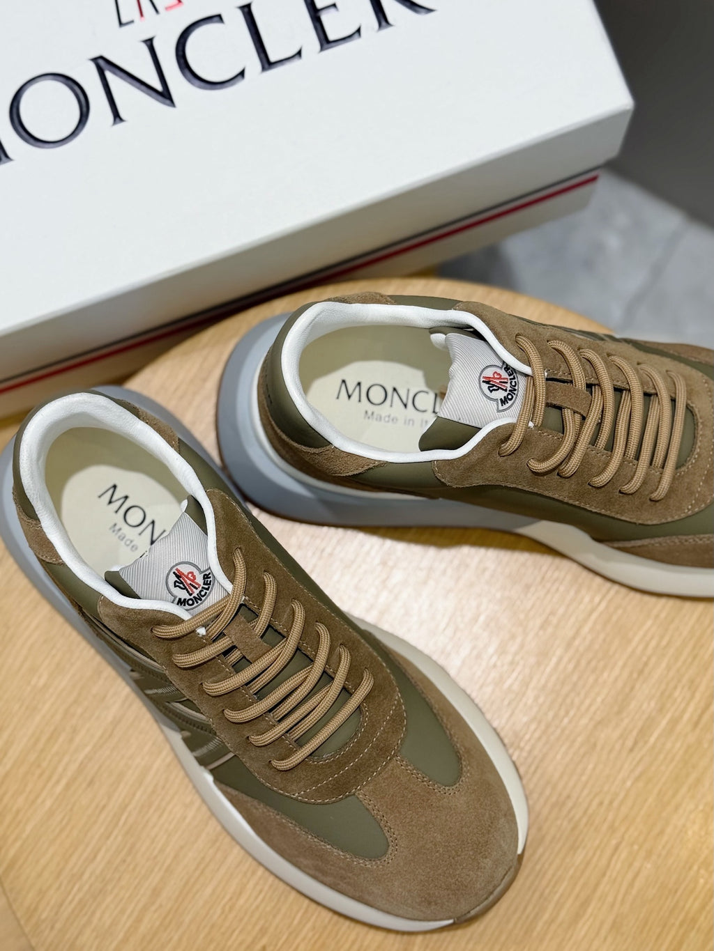 Moncler sneakers close-up on footbed, olive and tan suede with lace details