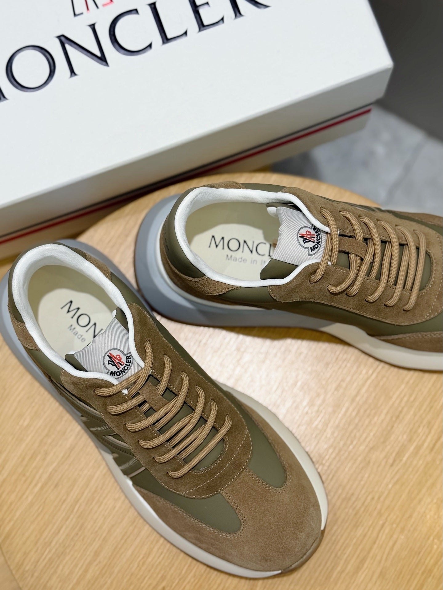 Moncler sneakers close-up on footbed, olive and tan suede with lace details