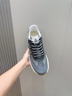 Dark blue suede lace-up sneaker with white trim and front lace-up panel