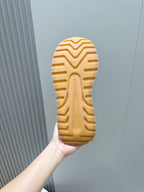 Shoe outsole with zigzag tread pattern in light tan rubber
