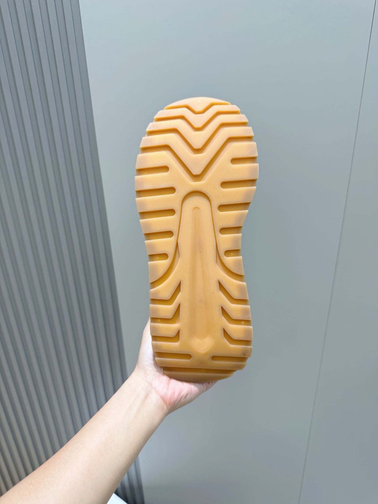 Shoe outsole with zigzag tread pattern in light tan rubber