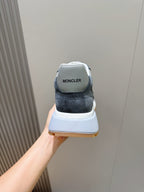 Back view of dark blue suede lace-up sneakers with Moncler on the heel tab