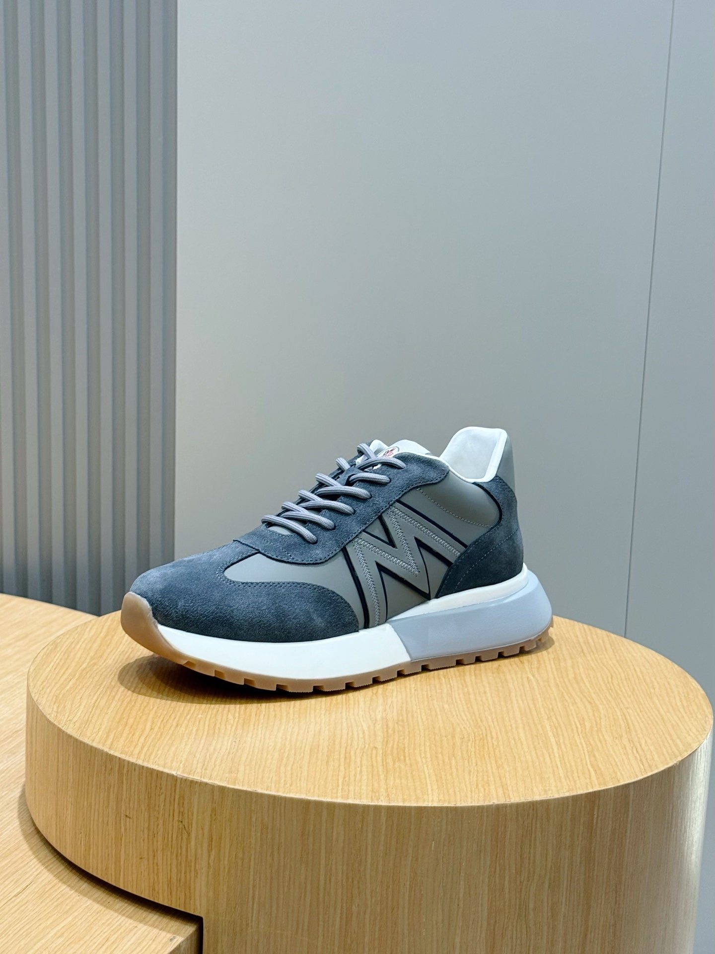 Dark blue suede lace-up sneakers with gray N logo and white sole