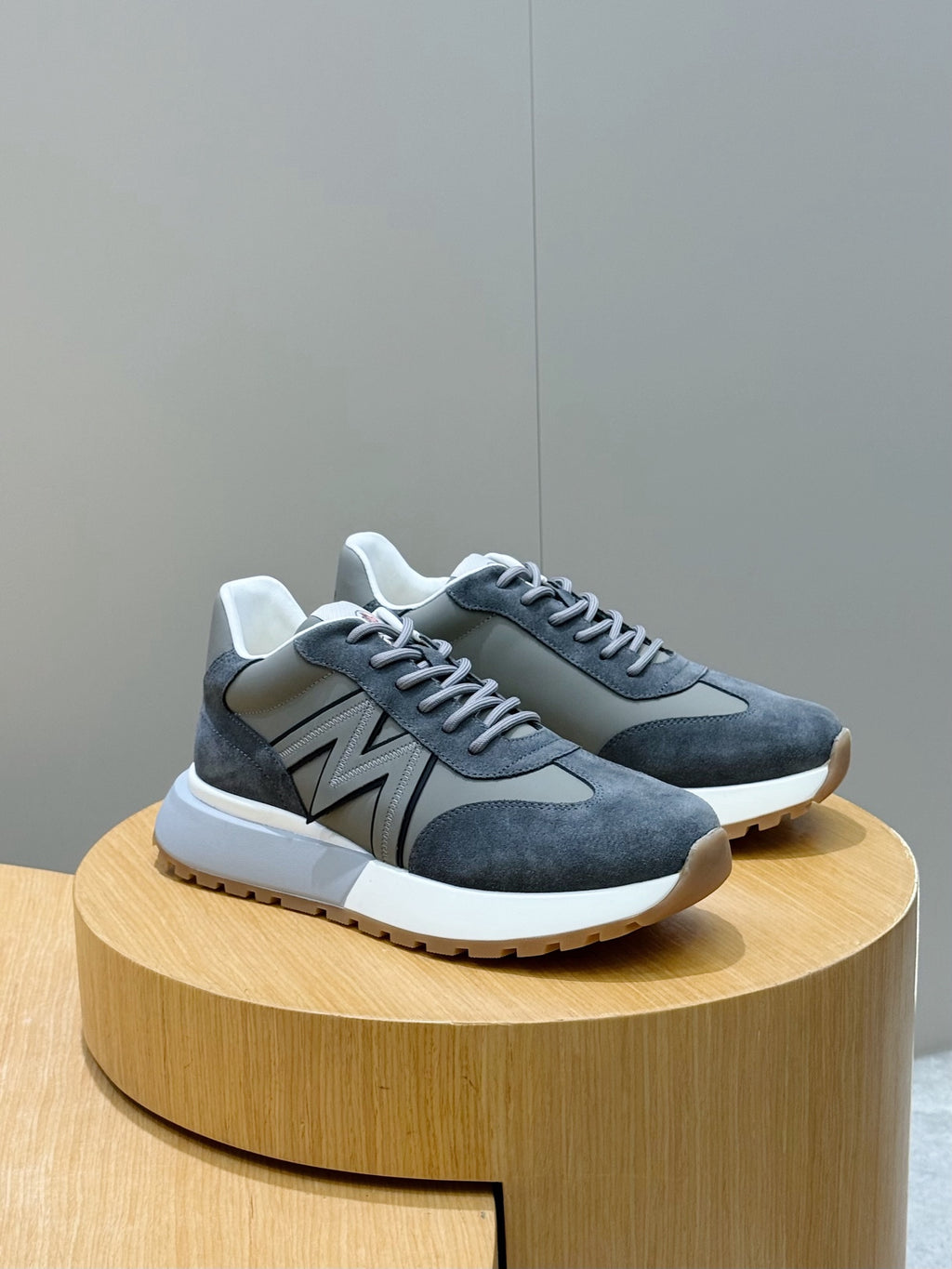 Dark blue suede lace-up sneakers with gray N logo and white midsole
