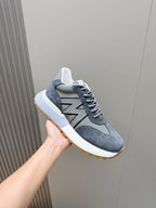 Dark blue suede lace-up sneakers with gray N logo and white sole with gum edge