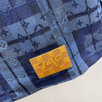 Blue patterned shirt jacket with yellow logo patch on the pocket area