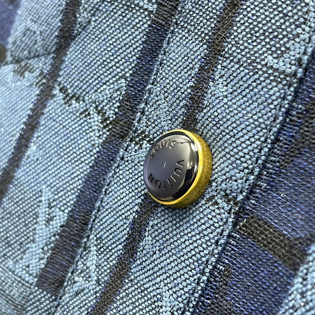 Blue patterned fabric with round gold button on long-sleeve shirt jacket