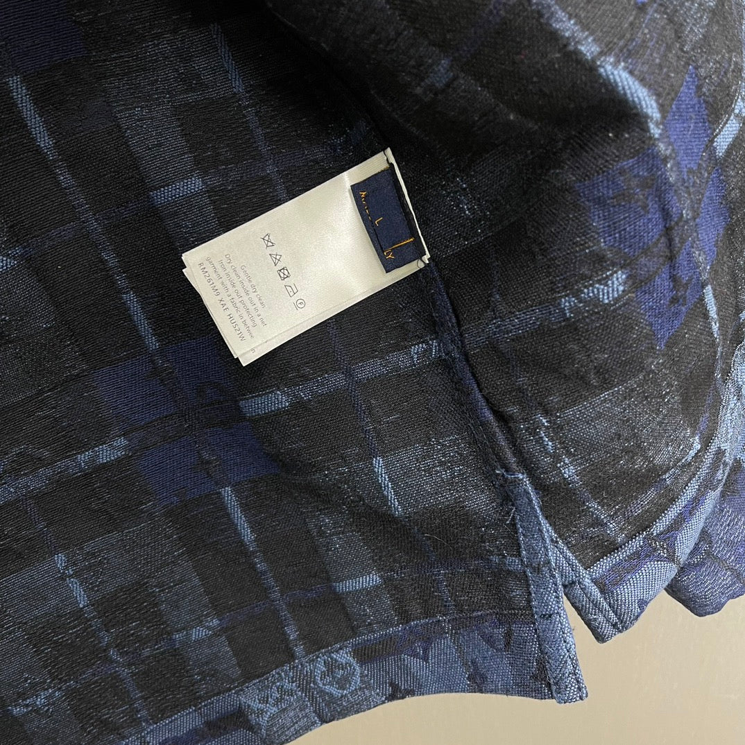 White care label sewn inside on blue patterned shirt jacket fabric