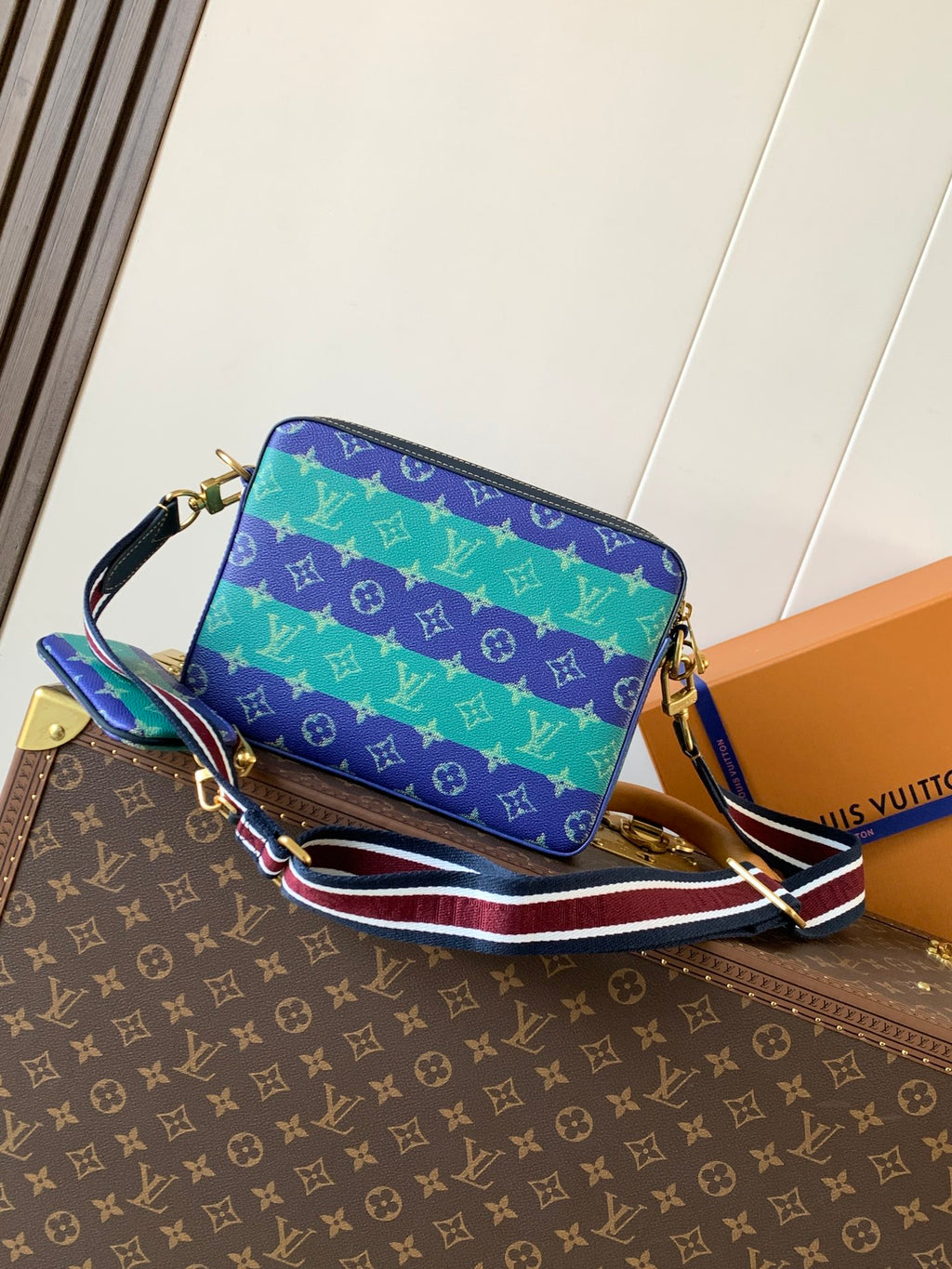 Louis Vuitton men’s crossbody bag in blue, purple, and green with striped strap