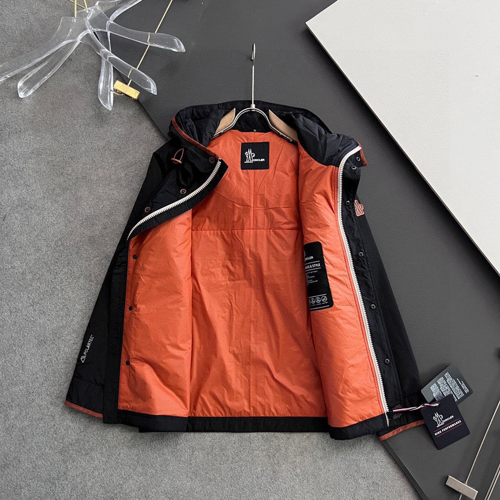 Long jacket with orange interior lining and black shell, hooded with zip front