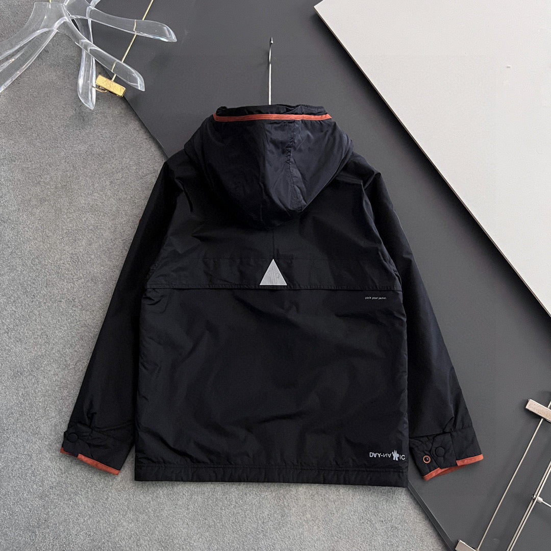 Long black winter jacket back view with hood, orange trim and chest logo