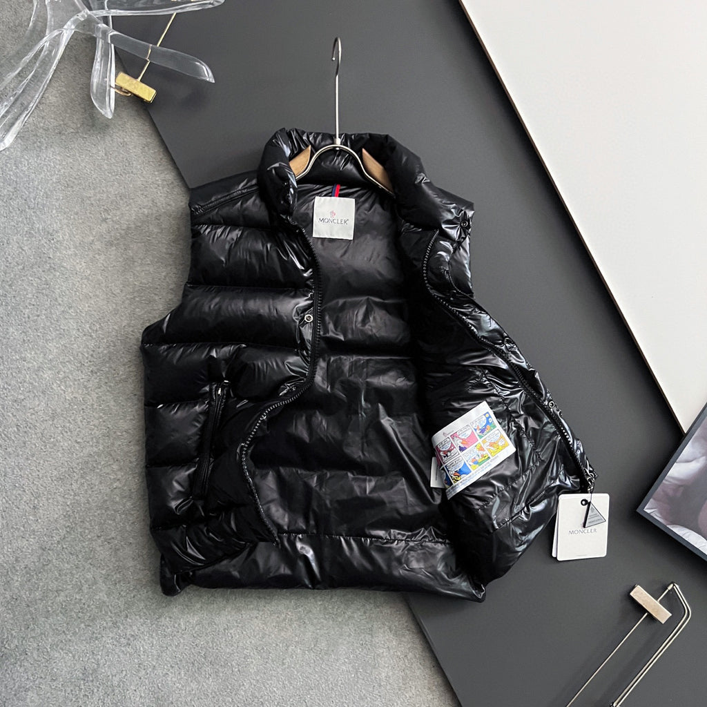 Black long puffer jacket with hood, front snap buttons, and product tags
