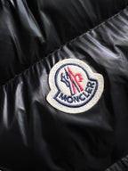Circular logo patch on black puffer jacket sleeve