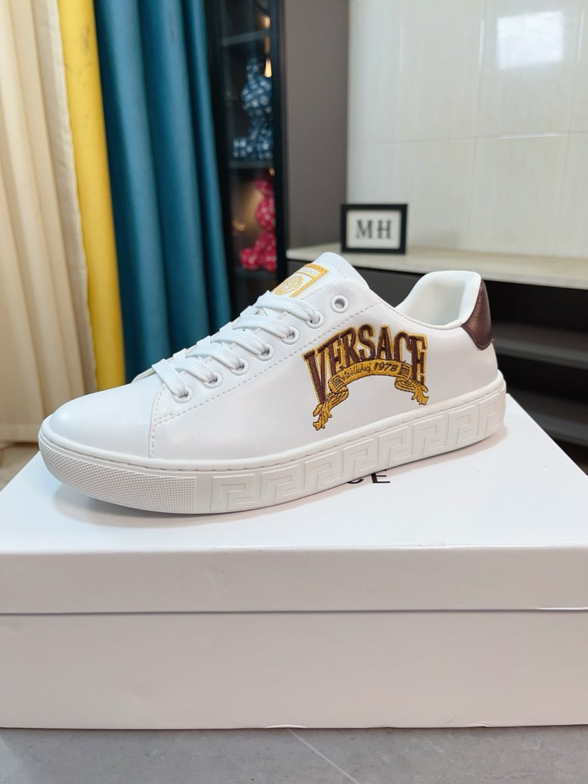 White Versace low-top sneakers with gold Medusa logo and brown heel tab