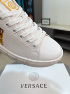 White sneaker toe with lace-up eyelets and gold VERSACE crest detail