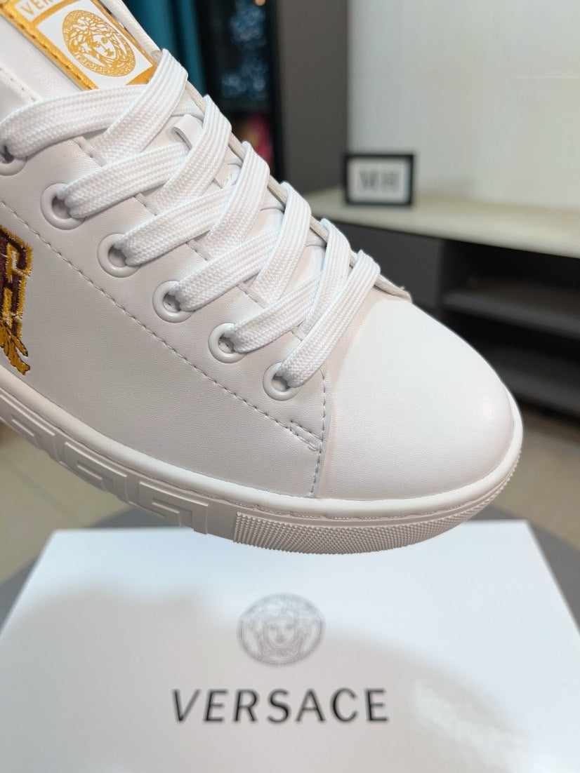 White sneaker toe with lace-up eyelets and gold VERSACE crest detail