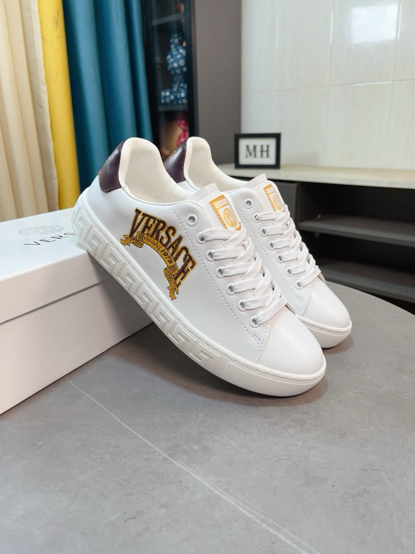 White Versace low-top sneakers with gold VERSACE crest and dark-brown heel accents