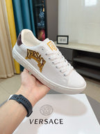 White Versace low-top sneakers with gold VERSACE crest and embossed Greek-motif sole