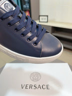 Versace sneakers close-up: dark navy lace-up upper with branded tongue patch