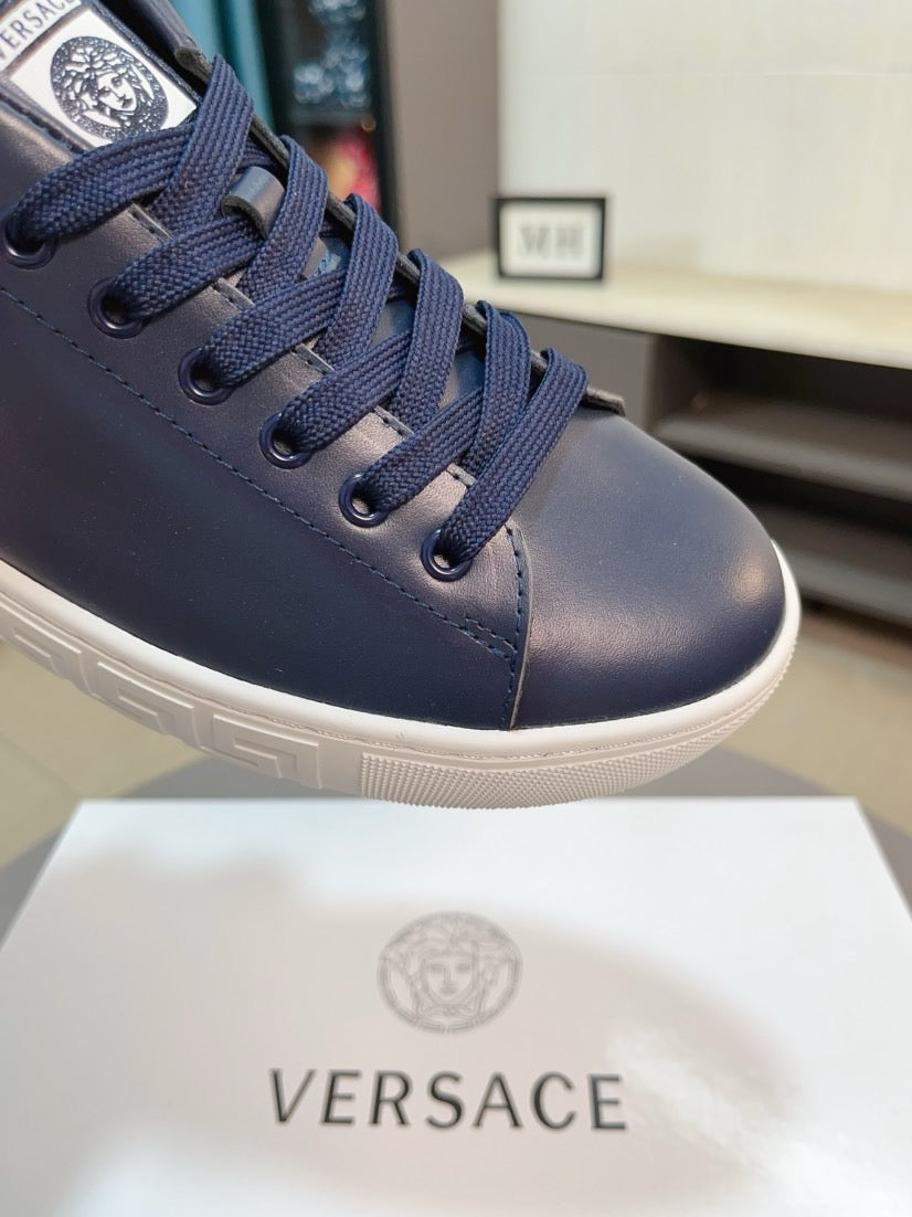 Versace sneakers close-up: dark navy lace-up upper with branded tongue patch