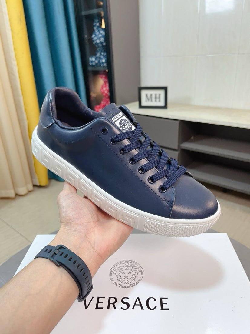 Versace sneakers in dark navy with lace-up front, cushioned collar, and white sole