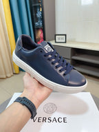 Versace sneakers in dark navy with lace-up front, cushioned collar, and white sole