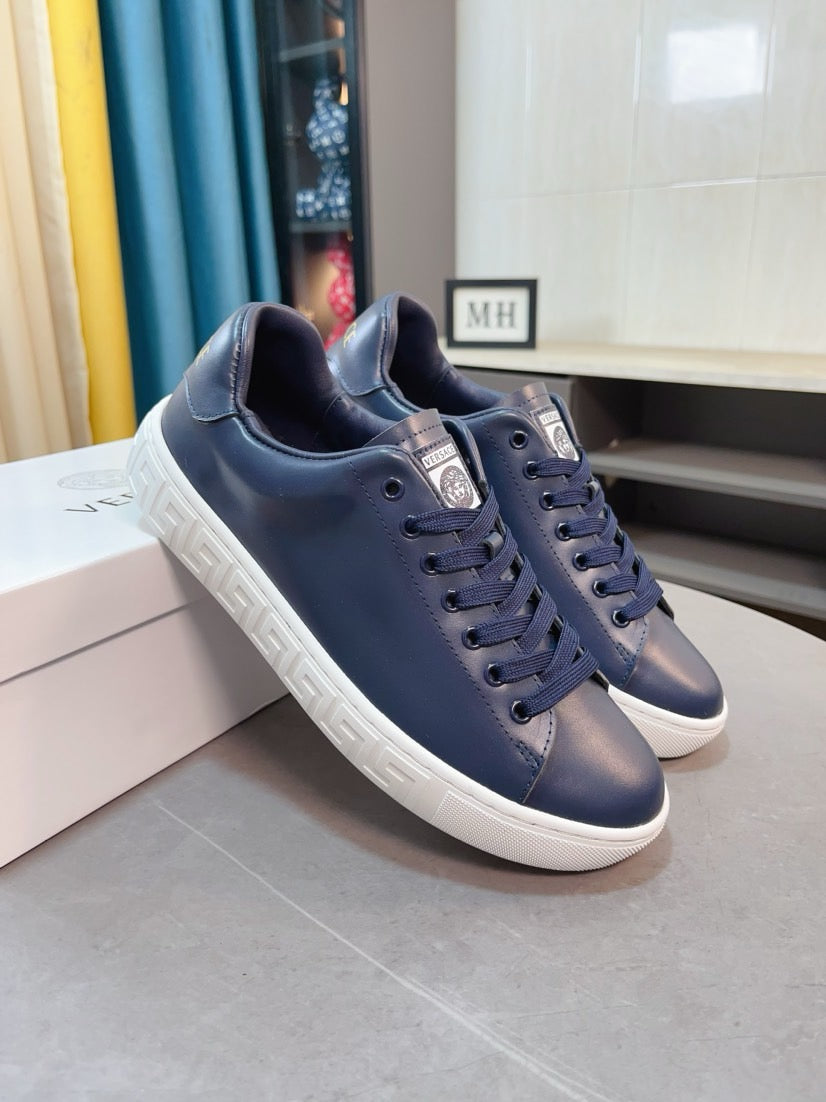 Versace sneakers pair in dark navy low-top lace-ups with white sole and logo patch
